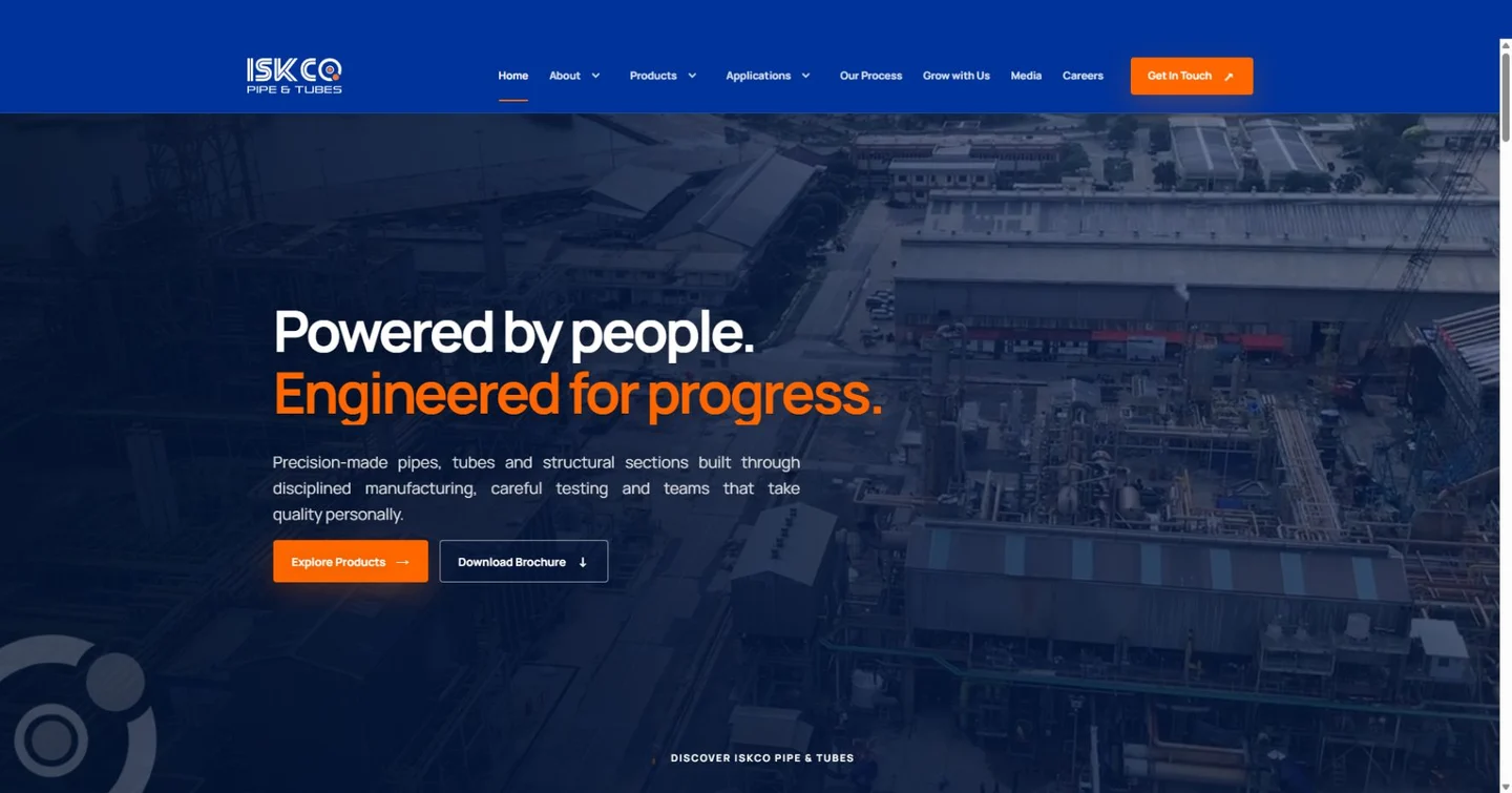 ISKCO Pipe and Tubes homepage with a steel manufacturing plant and blue and orange branding